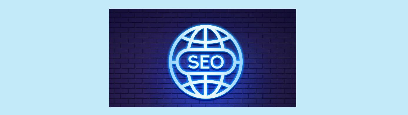 Beginners Guide to International SEO Strategies for Global Reach (3).
Light blue background.
Brick wall background cast in blue light of a international logo in silver,  SEO in silver in the center.