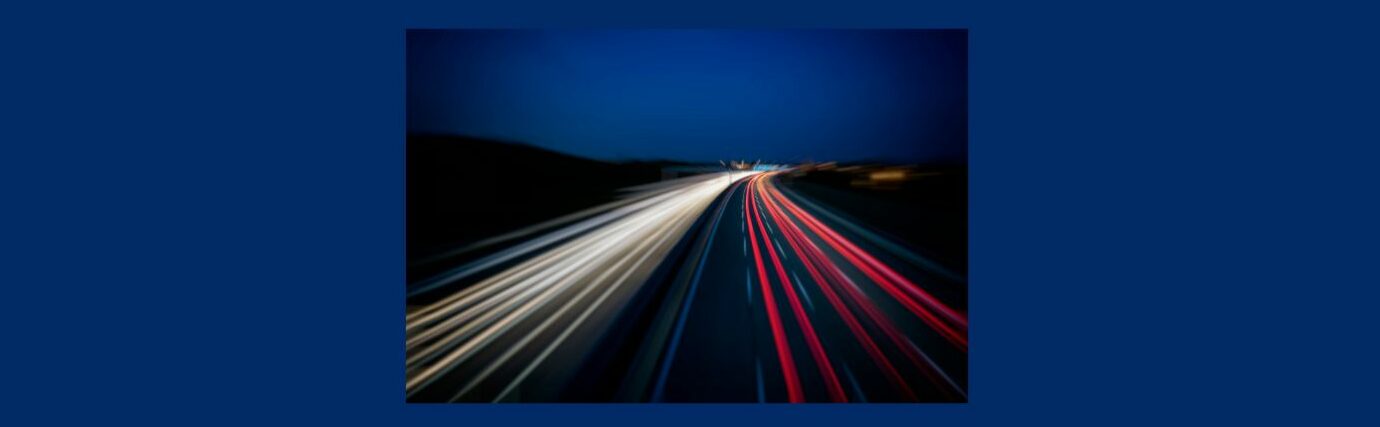 How to Get Free Traffic for Your Website (7).
Dark blue background, Night sky, divided highway,  white lights on the left, red on the right.