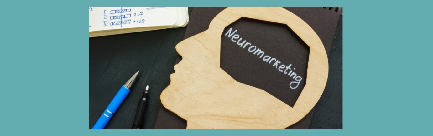 Unlocking Consumer Minds The Power of Neuromarketing in Affiliate Marketing (5)
Light blue background, Black table, top left white papers with blue ink, circle graphs, bar graphs. Top right the cap of a white marker. Black notebook, spiral on top. A wood cut out of human head, section in middle cut out Neuromarketing in white letters. Bottom left, blue pen, and tip of marker.