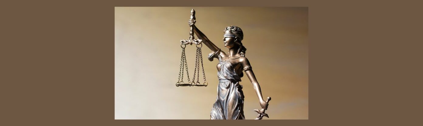 Ethical Practices on Social Media for Affiliate Marketers (5).
Medium brown background.
Bronze statute woman in dress, right arm up, holding scales with chains and a bar a the top, left hand down holding sword.  Dark surface. Back ground light brown swipes.