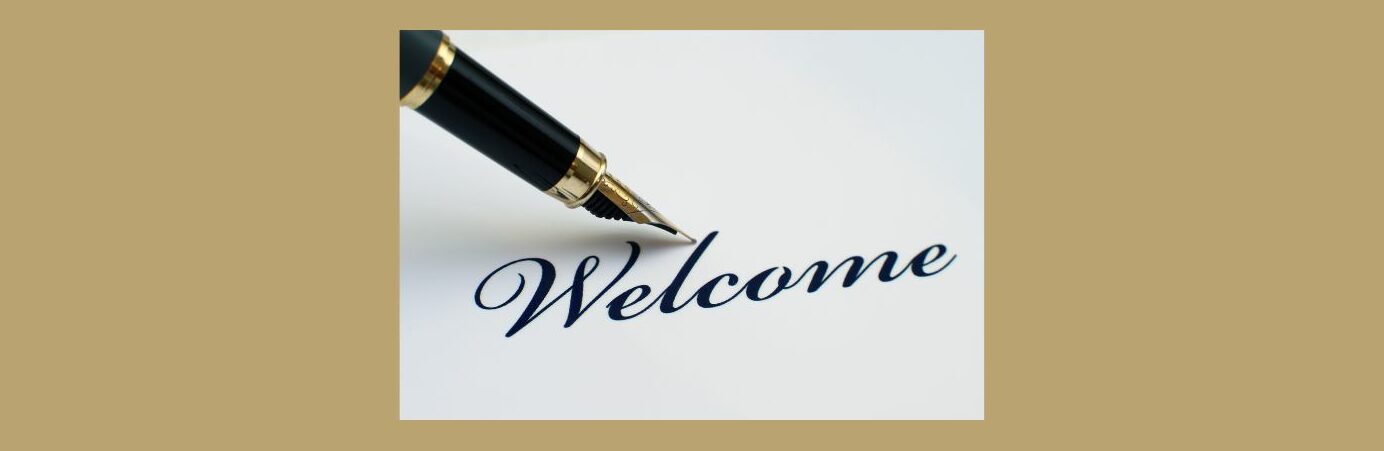 How to Write a Great Welcome Email for Your New Customers (2).
Light brown background, white square in the middle. 
Welcome in cursive, black ink.
Black and gold calligraphy pen the point next to the "l".